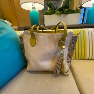 Leather shoulder bag with snake print on the side.